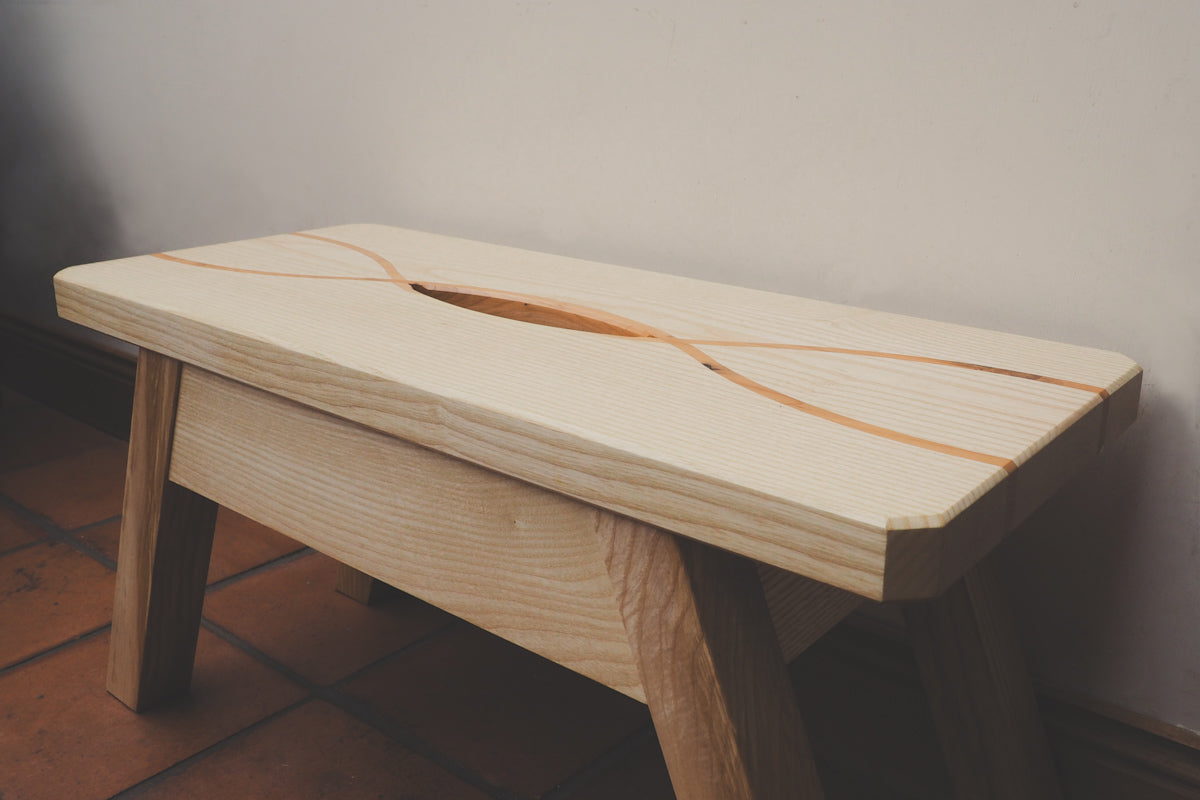 A criss-cross pattern is formed on the stool top from a contrasting yew wood