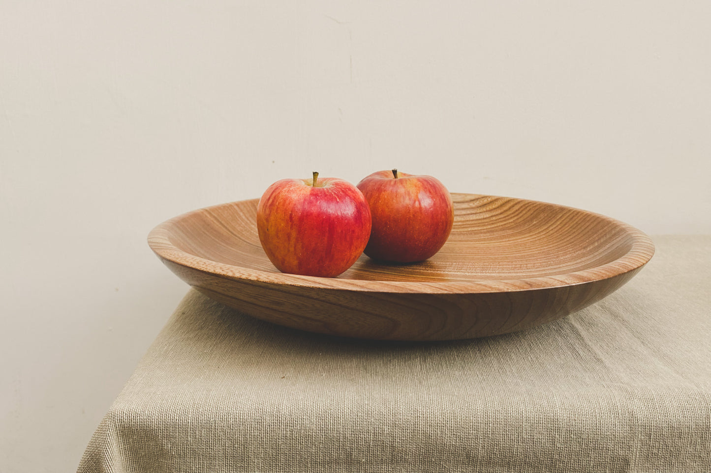 Handturned, shallow wooden bowl. Perfect for use as a fruit bowl in a modern kitchen.